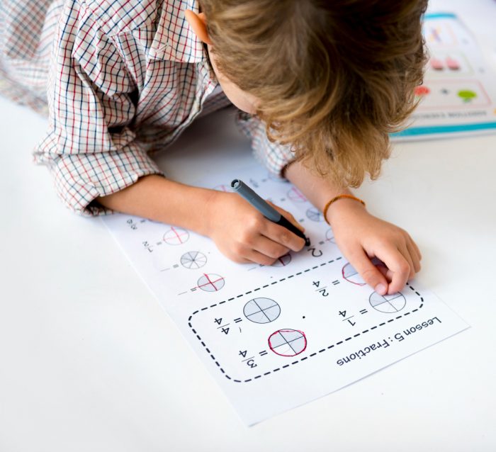 Kid Concentrating with Mathematics Homework Learning