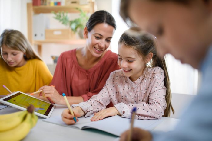 Group of children with teacher studying 